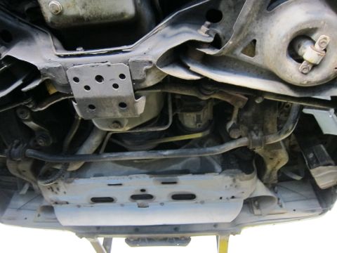 1991 Ford LTD Crown Victoria - Undercarriage view looking up at front crossmembers, stamped-steel brackets and suspension mounting points.