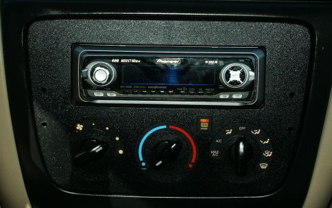 2001 Ford Taurus - Close-up of a car's interior dashboard, focusing on the aftermarket stereo and climate control panel.