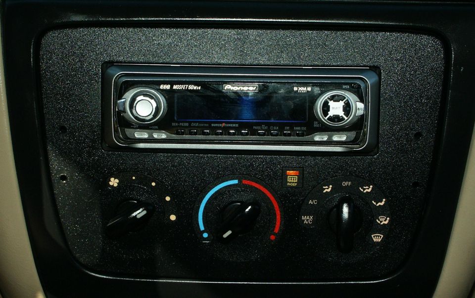 Car dashboard showing a Pioneer stereo and climate controls with fan speed and temperature dials