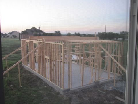 1995 Ford Bronco - Construction site shows the wooden frame of a house being built on a concrete foundation.