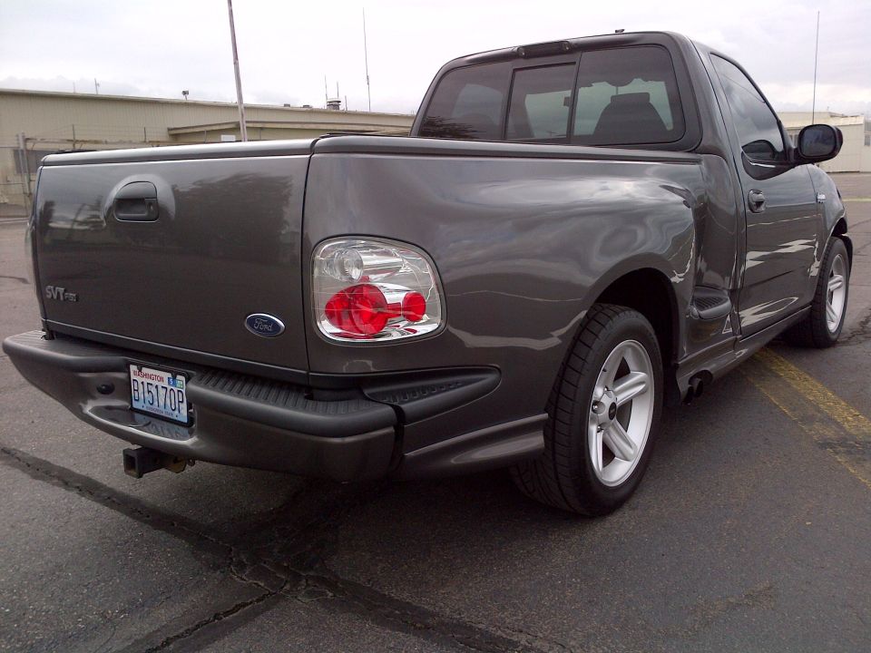 2003 Ford F-150 SVT Lightning pickup truck, rear quarter view. Washington license plate B15170P