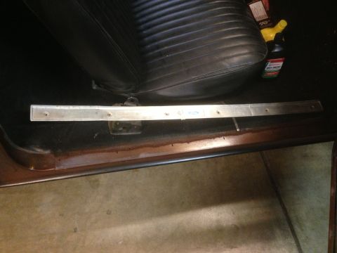 1972 Ford Ranchero - The interior of a 1972 Ford Ranchero shows a rusty door sill and a black vinyl seat.