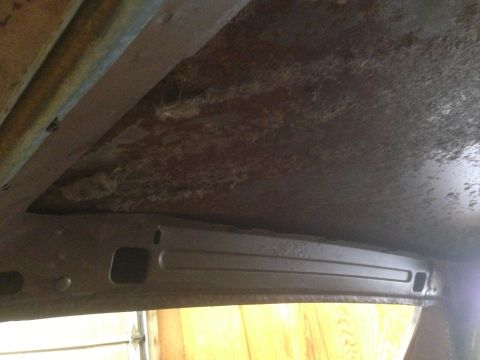 1972 Ford Ranchero - The interior ceiling of a vehicle shows significant rust and deterioration.