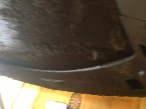 1972 Ford Ranchero - The photo shows a dark, textured surface inside a vehicle, possibly a dashboard or door panel.