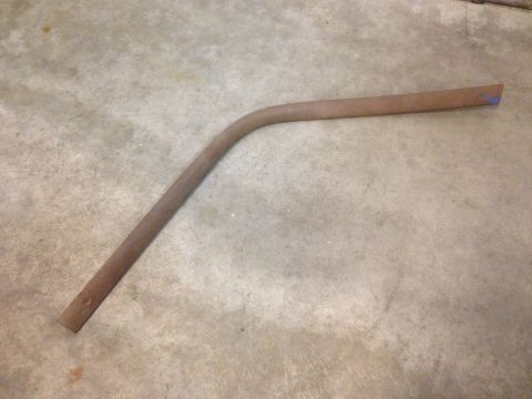 1972 Ford Ranchero - A single, rusted metal rod with a distinct bend is shown on a concrete surface.