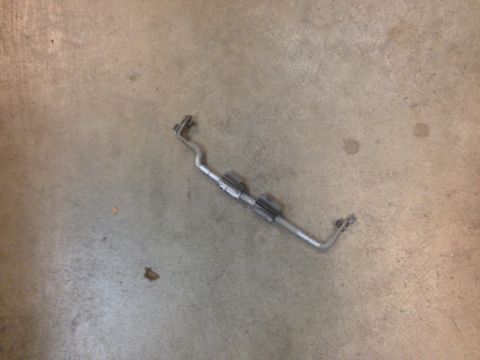 1972 Ford Ranchero - A metal bar with attached brackets rests on a concrete surface.