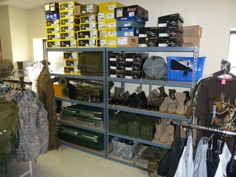 1992 Ford Mustang - Shelves are filled with various items including boxes, boots, and military-style clothing.