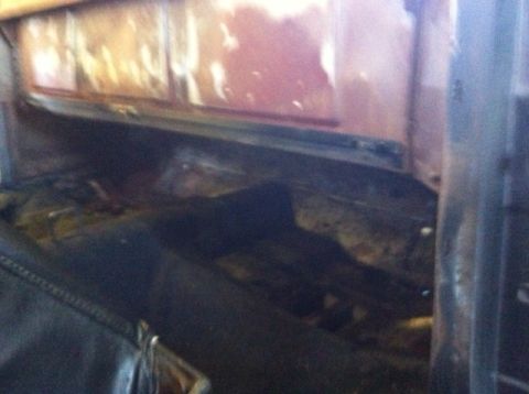 1972 Ford Ranchero - Interior view of a vehicle's worn flooring and dashboard area.