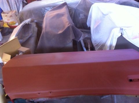 1972 Ford Ranchero - A red car door sits in front of other vehicles covered in protective tarps in a garage.