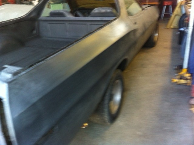 1972 Ford Ranchero side view, primer finish, in garage