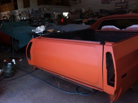 1972 Ford Ranchero - Rear view of an orange 1972 Ford Ranchero undergoing restoration in a garage.