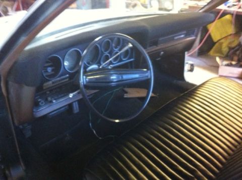 1972 Ford Ranchero - The interior of a 1972 Ford Ranchero shows its dashboard, steering wheel, and ribbed seat upholstery.