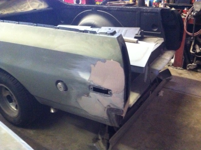 1972 Ford Ranchero rear quarter panel undergoing bodywork, showing primer and filler