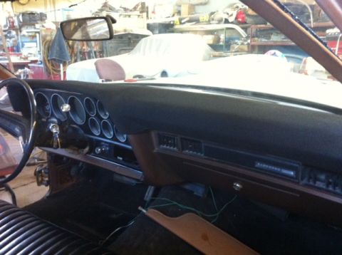 1972 Ford Ranchero - Interior view of a 1972 Ford Ranchero, showing the dashboard and seats in a workshop setting.
