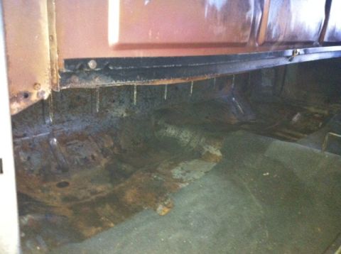 1972 Ford Ranchero - The interior of this vehicle shows significant rust and wear on the floor and lower door panel.