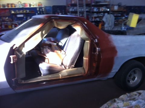 1972 Ford Ranchero - This 1972 Ford Ranchero is undergoing repairs in a workshop, with its interior and primer-covered rear visible.
