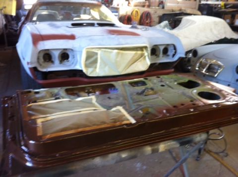 1972 Ford Ranchero - Car door and front end of a 1972 Ford Ranchero in a workshop, likely during restoration.