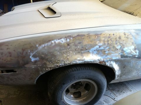 1972 Ford Ranchero - This 1972 Ford Ranchero shows significant body damage and rust on the rear fender, indicating it is undergoing restoration.