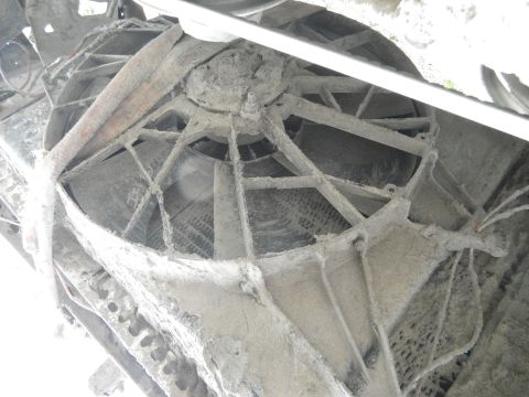 1980 Ford Bronco - Close-up view of a dusty radiator fan assembly, likely from an older vehicle.