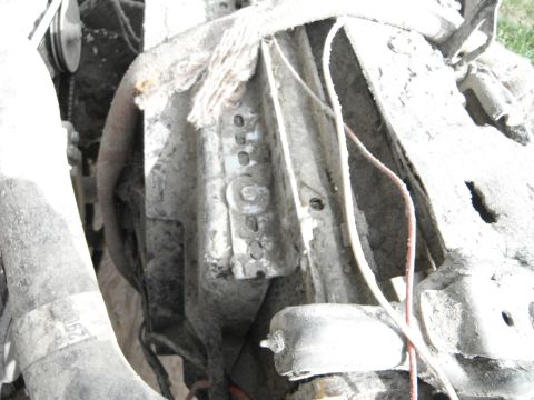 1980 Ford Bronco - Engine component detail, likely from a radiator section, showing grime and wiring.