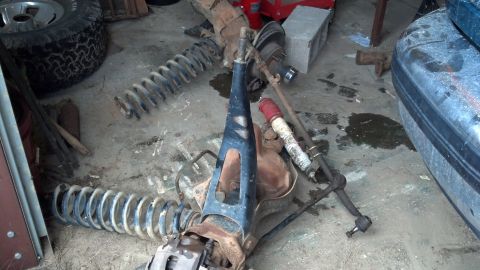 1996 Ford F-150 - Various suspension components, such as coil springs and shock absorbers, are laid out on a concrete floor.