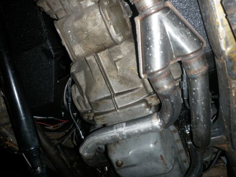 1961 International Scout 800 - Underside view of a vehicle's transmission and exhaust system components, showing a Y-pipe collector.