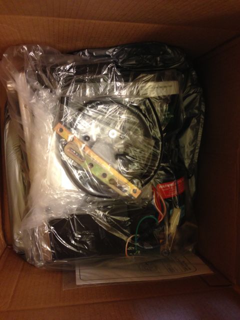 1964 Ford Fairlane - Unidentified automotive part, wrapped in plastic, inside a cardboard box.