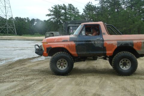 1978 Ford Bronco - Modified 1978 Ford Bronco with custom bumper and roll cage seen off-roading.