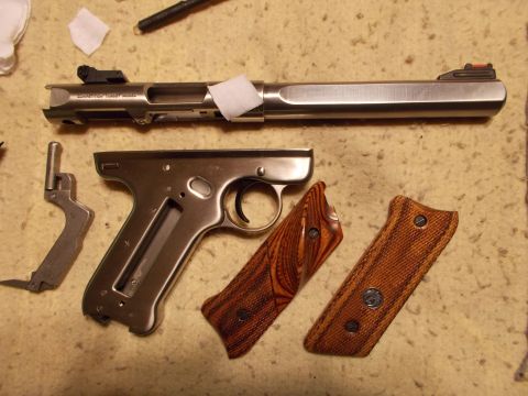 2012 Ford Mustang - The components of a handgun are laid out on a textured surface, ready for assembly or cleaning.