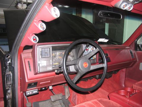 1990 Chevrolet Silverado 1500 - The interior of a 1990 Chevrolet Silverado 1500 shows a custom gauge pod mounted on the A-pillar.