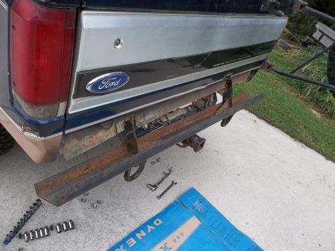1995 Ford Bronco - The rear of a blue Ford Bronco, with its bumper removed, displays the Ford emblem.