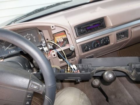 1995 Ford Bronco - Dashboard disassembled in a 1995 Ford Bronco, revealing wiring and an aftermarket stereo unit.