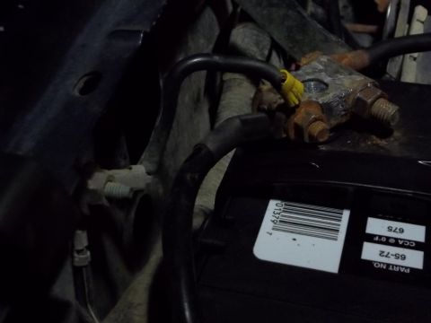 1995 Ford Bronco - Corroded battery terminals and wiring are visible in this close-up shot, with a part number label on the battery.