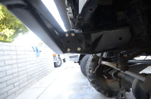 1979 Ford Bronco - Close-up view of the undercarriage of a 1979 Ford Bronco, highlighting its running boards and suspension components.