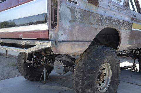 1979 Ford Bronco - This lifted truck shows off its custom rear bumper and fender modifications, with large off-road tires visible.