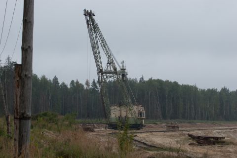 1987 Ford Bronco - A large dragline excavator sits idle in a landscape with trees and industrial equipment.