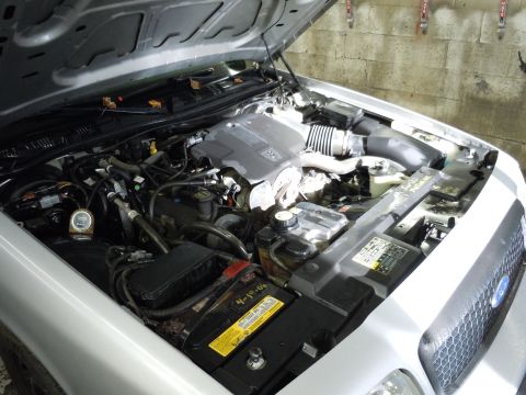2001 Ford Crown Victoria - Engine bay of a 2001 Ford Crown Victoria, showing the engine and various components under the open hood.
