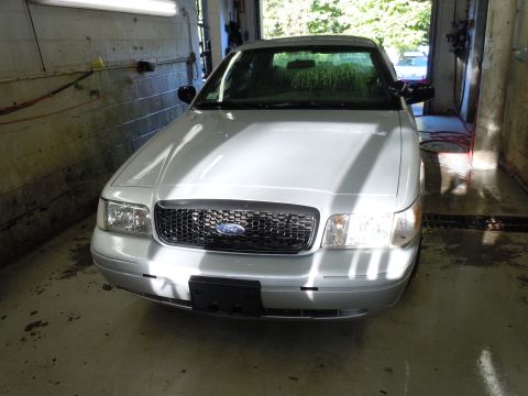 2001 Ford Crown Victoria - Front view of a silver 2001 Ford Crown Victoria in a garage.