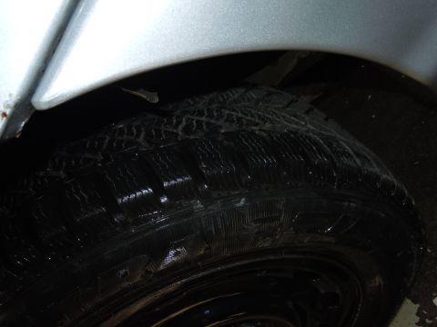 2001 Ford Crown Victoria - A close-up view of a tire and the surrounding wheel well, with no visible identifying marks.