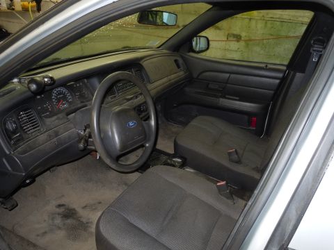2001 Ford Crown Victoria - The interior of a 2001 Ford Crown Victoria, a police-style steering wheel and dashboard.