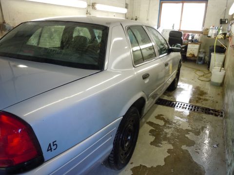 2001 Ford Crown Victoria - Silver 2001 Ford Crown Victoria in a garage, showing the rear passenger side.