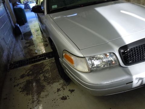 2001 Ford Crown Victoria - Front corner view of a silver 2001 Ford Crown Victoria parked indoors.