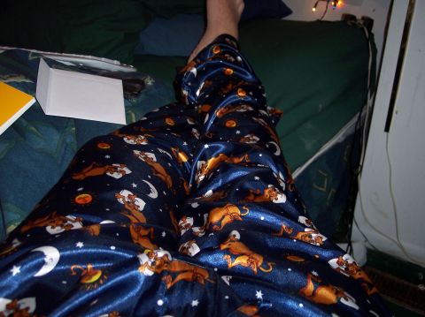 1990 Ford Bronco - A person is seen wearing blue pajamas with a Scooby-Doo theme while relaxing on a bed.