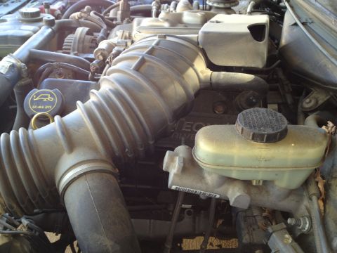 1998 Ford Crown Victoria - Close-up of a Ford V8 engine bay, showing the air intake and brake fluid reservoir.