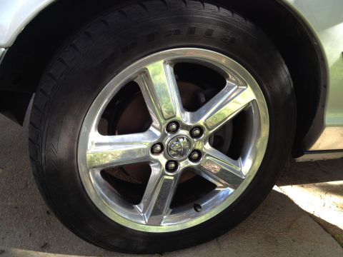 1998 Ford Crown Victoria - Close-up of a car's wheel and tire, showing the tread pattern and alloy rim.