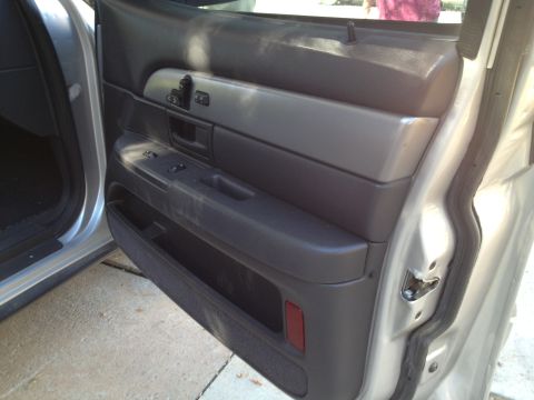 1998 Ford Crown Victoria - Close-up view of the interior door panel of a car, revealing the window controls and door latch mechanism.