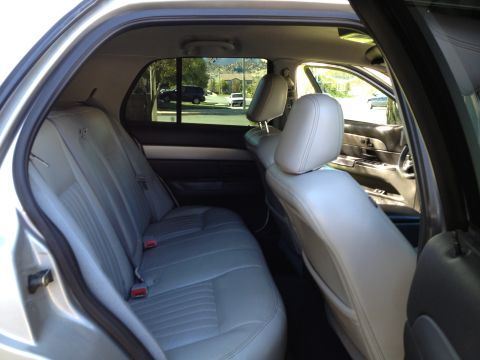 1998 Ford Crown Victoria - The interior of a car, showing the back seat and a view of the dashboard and front seats.