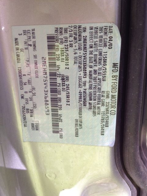 1998 Ford Crown Victoria - A close-up of a vehicle's identification and manufacturing label, providing details about its specifications.