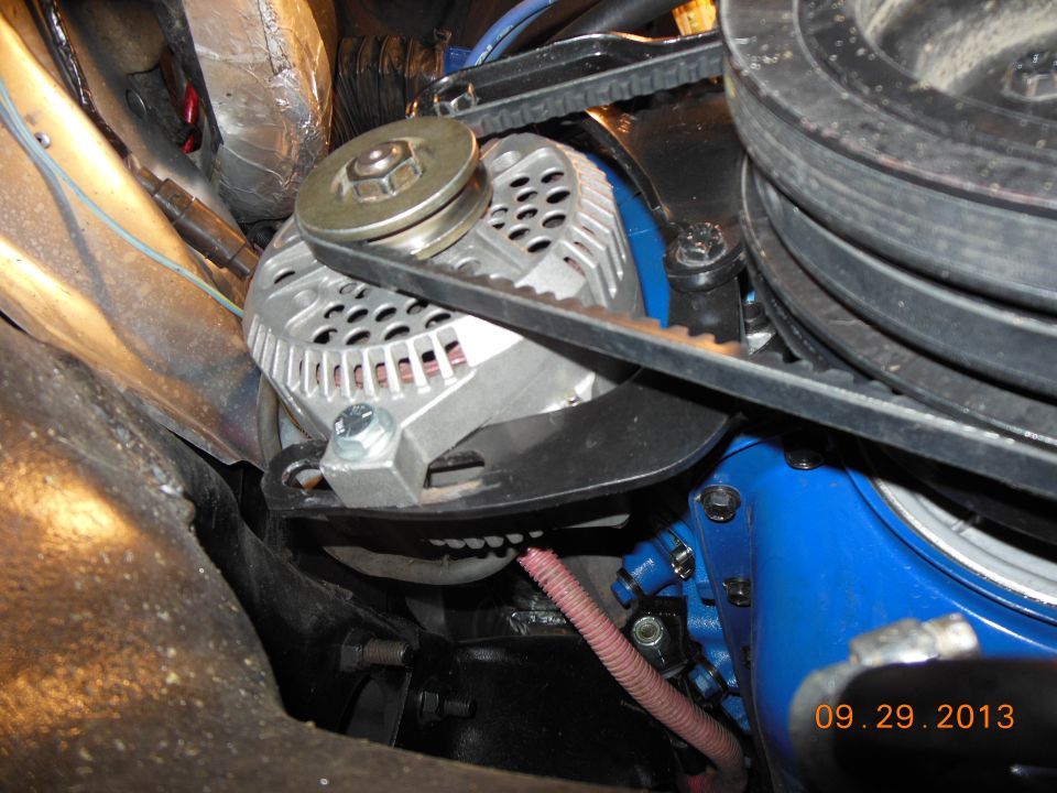 Alternator with blue engine block and drive belts