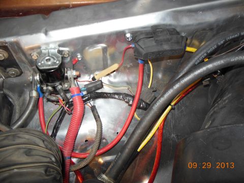1979 Ford F-150 - Close-up view of engine bay wiring and hoses, including a Bussmann fuse box and starter solenoid.